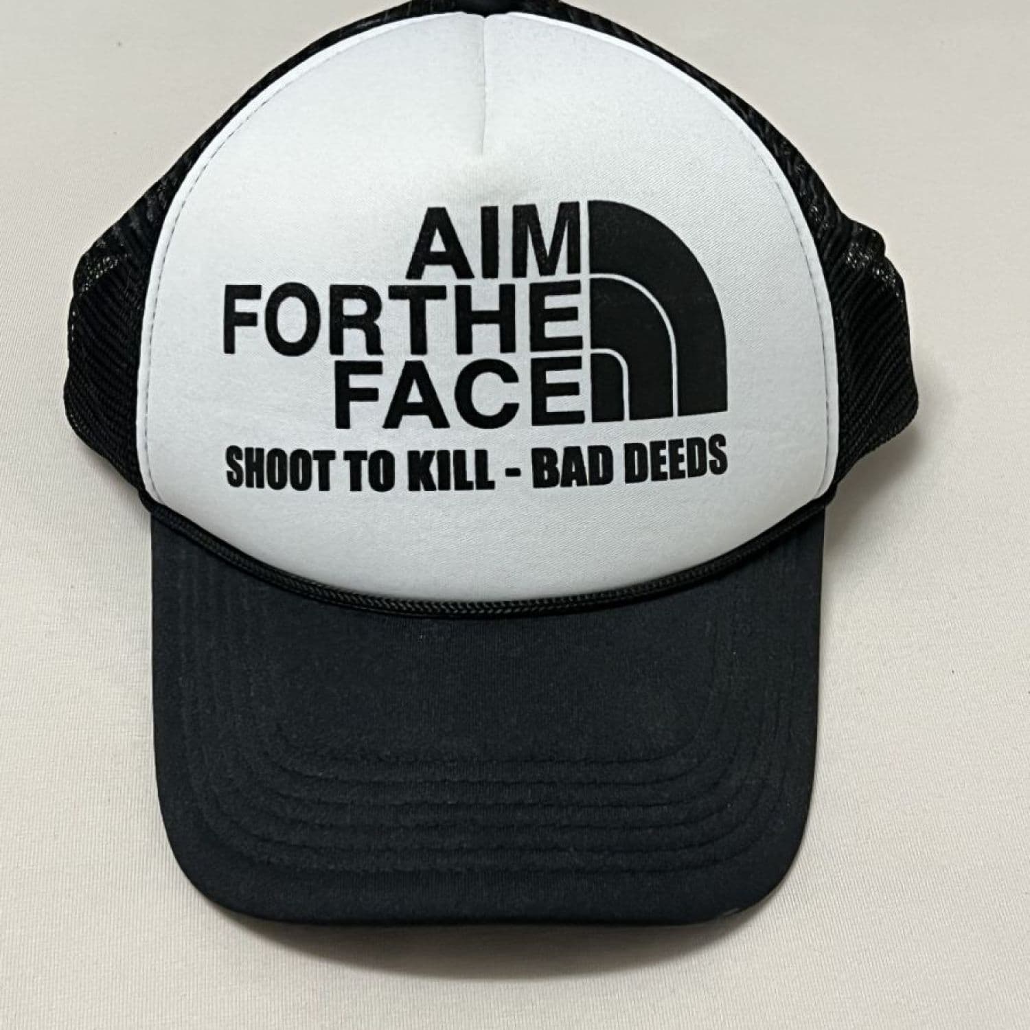 Bad Deeds Aim For The Face Trucker Cap